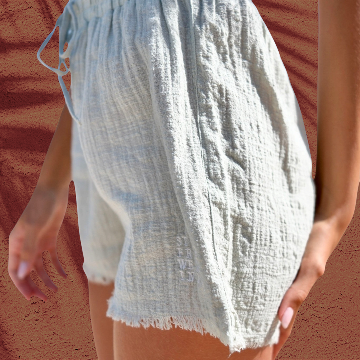Shorts Lina St Barth French West Indies en coton gaze blanc cassé avec broderie logo discrète et bord effiloché