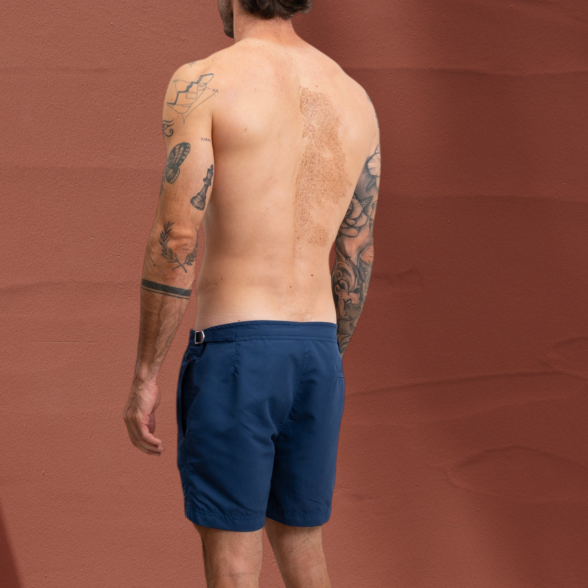 Homme portant un short de bain bleu St Barth French West Indies avec ajusteurs latéraux chromés, vue de dos